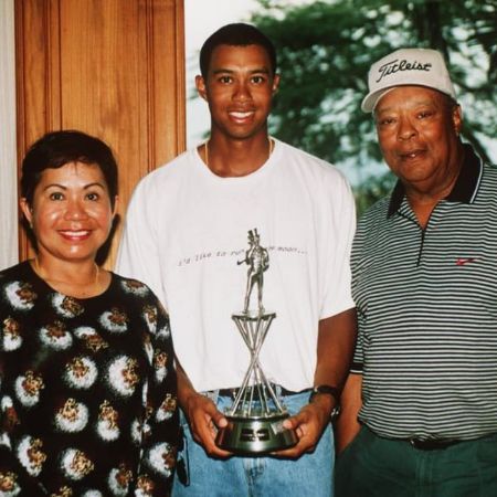 Woods with his husband and her son clicking a picture winning a trophy by his son.