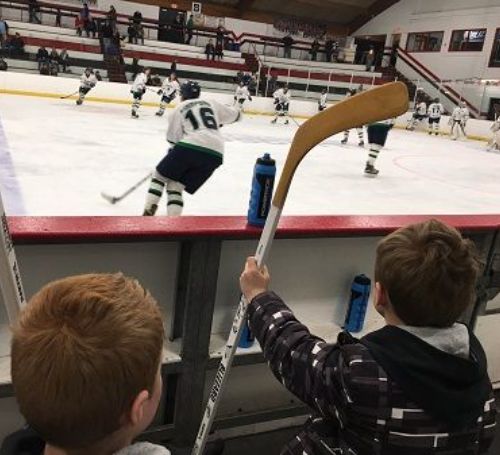 Turk Lesnar and his younger brother Duke Lesnar watching ice hockey.