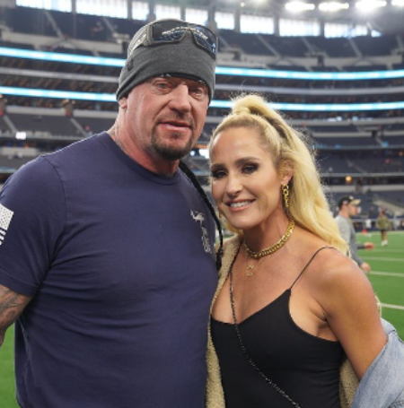 The Undertaker is with his daughter. 