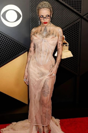 Doja Cat wore a see-through peach-colored gown that showed off all her tattoos. 